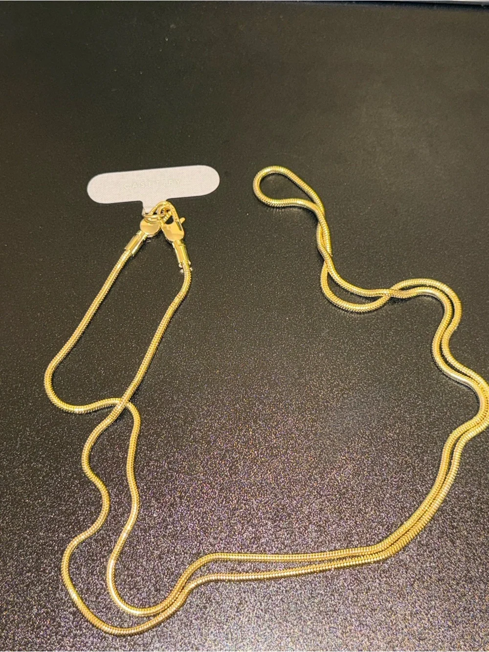 Casetify gold toned crossbody phone strap